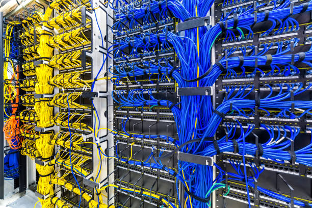 Rack with generic Ethernet cat5e cables, part of a large company data center. network cabling